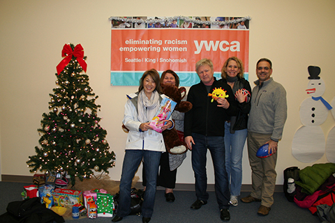 YWCA staff posing with a Christmas tree
