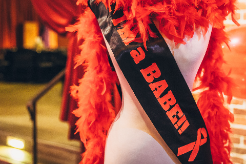 Mannequin wearing a boa and sash that says "I'm a BABE!!"