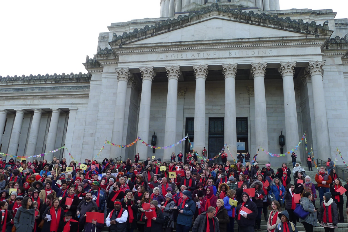 Photo of people standing outside of the Legislative House