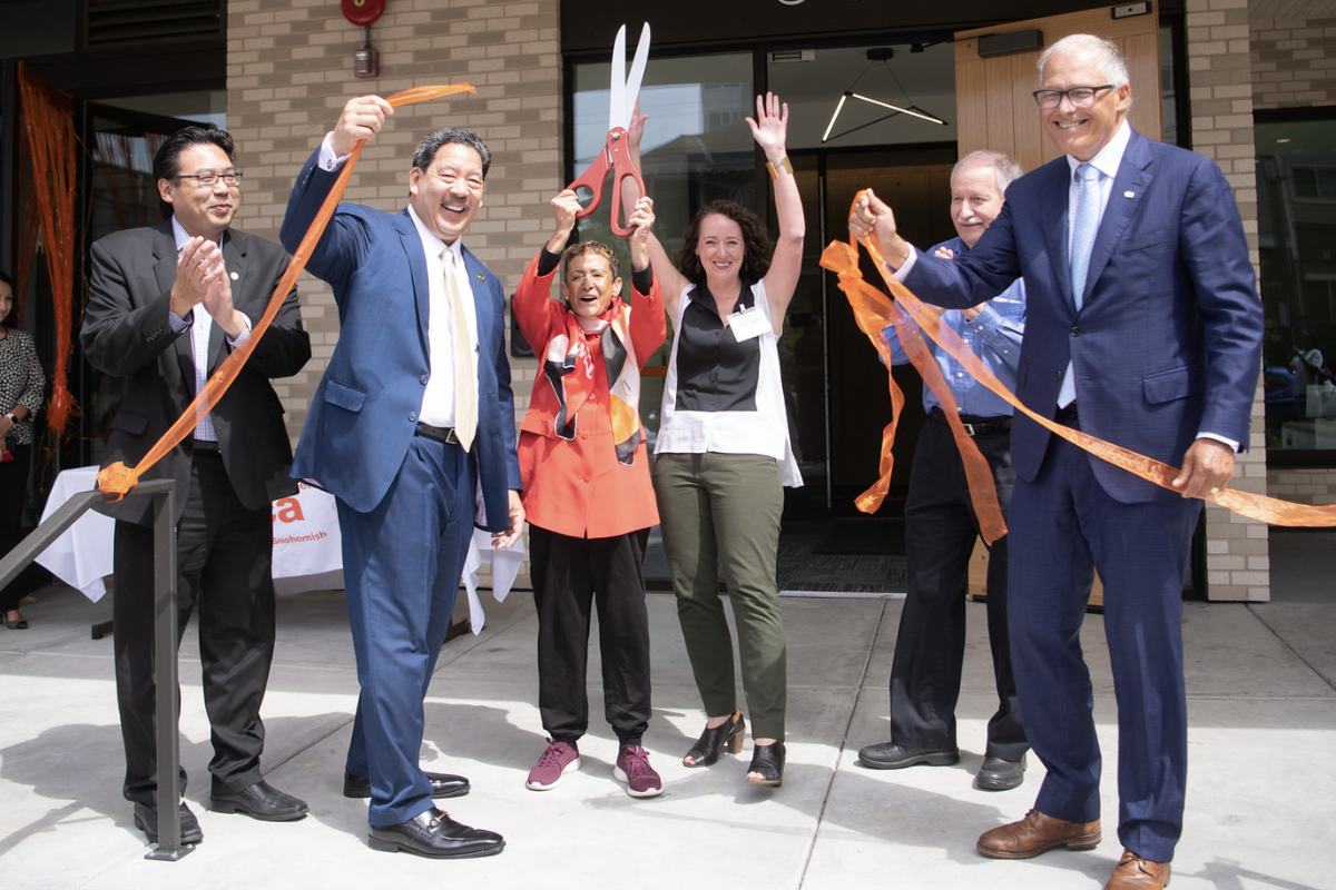 A photo of the ribbon cutting event at Denny Apartments