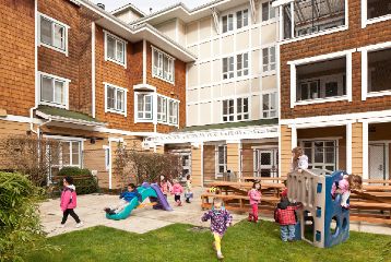 Kids play outside an affordable housing building