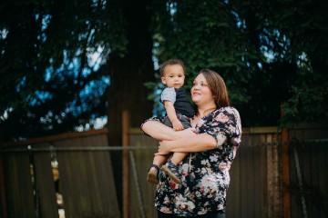 A woman holds her child