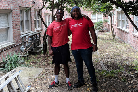 Photo of two volunteers outside