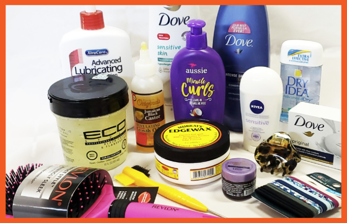 A photo of various personal care products, including lotion, wax, soap, hairties, and brushes.