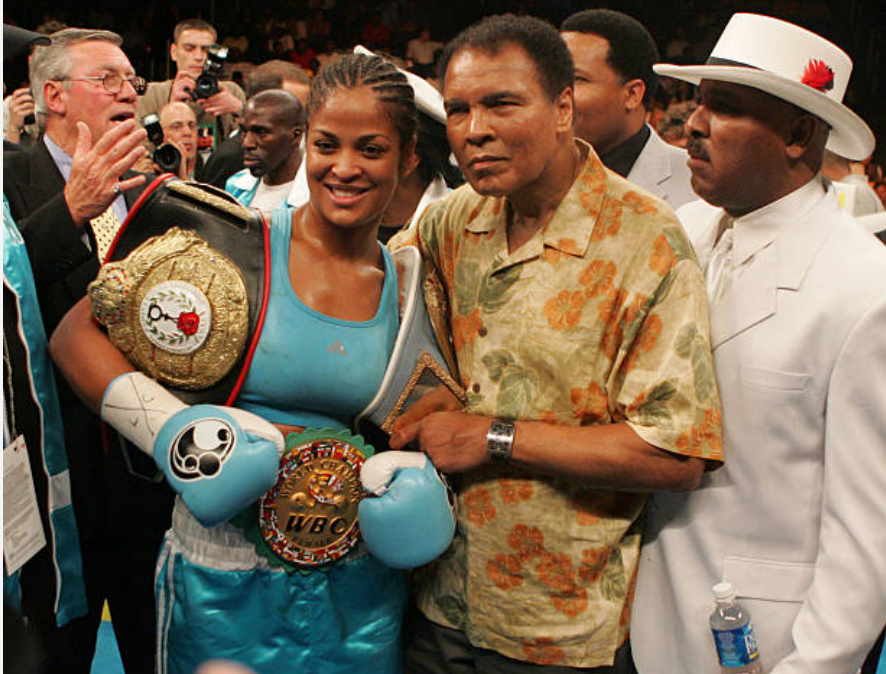 Laila Ali posing with her father, Muhammad Ali, after her 10 round WBC/WIBA Super Middleweight title bout with Erin Toughill in 2005.