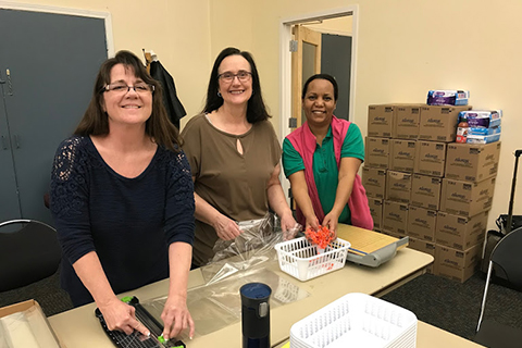 Photo of a group of volunteers packing supplies