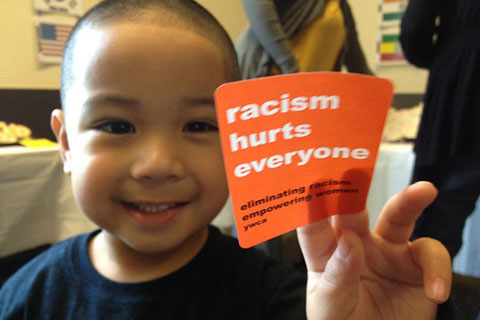 Child with "stand against racism" sticker