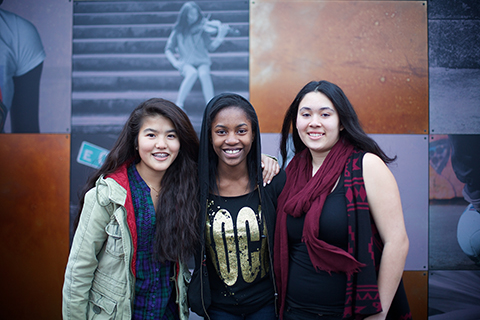 Three teenagers posing together for a picture