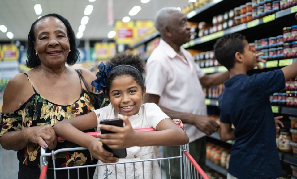 Photo of a family grocery shopping together.