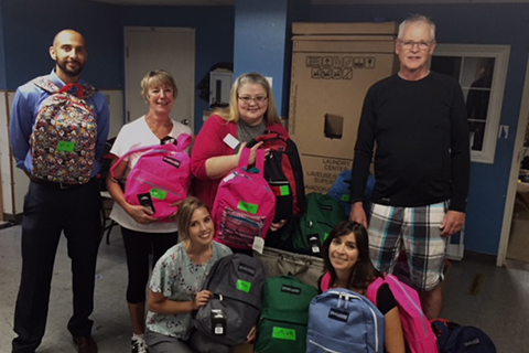 Volunteers packing donated school supplies