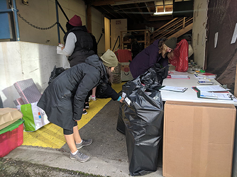 Adopt-a-Family volunteers organizing holiday donations