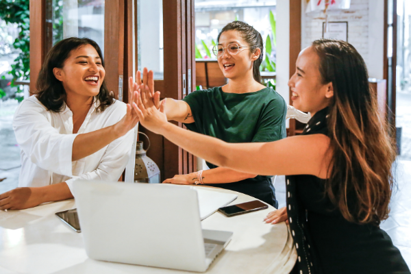 Picture of three BIPOC women high fiving