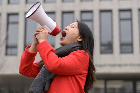 Photo of Asian American woman with a megaphone