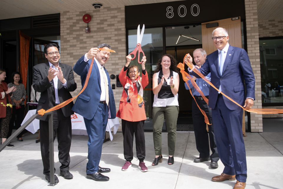 Photo of YWCA Seattle CEO Maria Chavez-Wilcox with guests at the East Denny ribbon cutting event