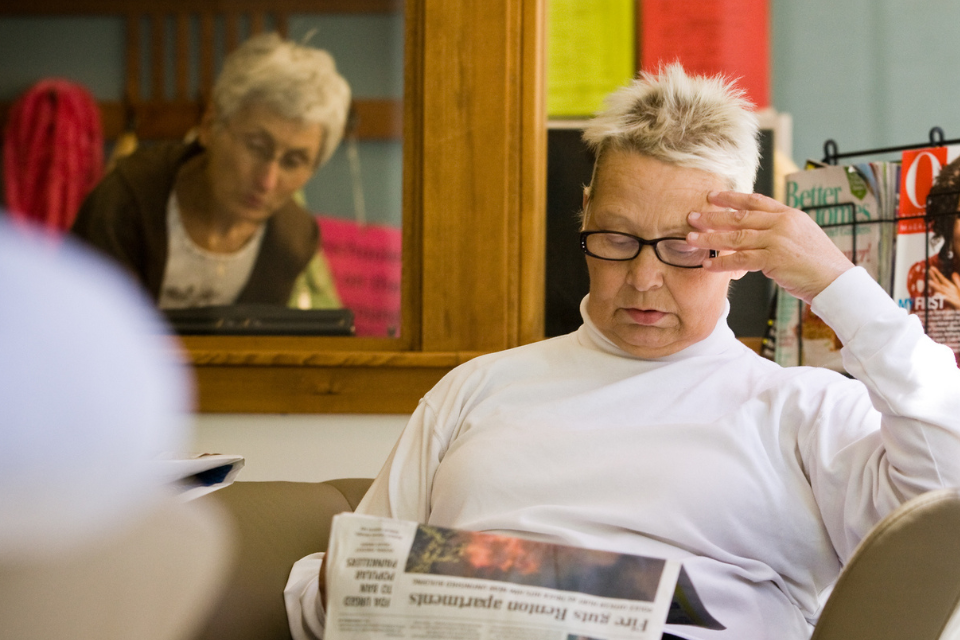 Photo of one of our Program participants reading a newspaper