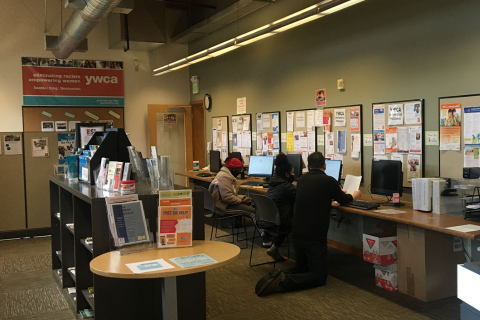 Picture of YWCA staff member helping visitors at Greenbridge Learning Center's computer lab