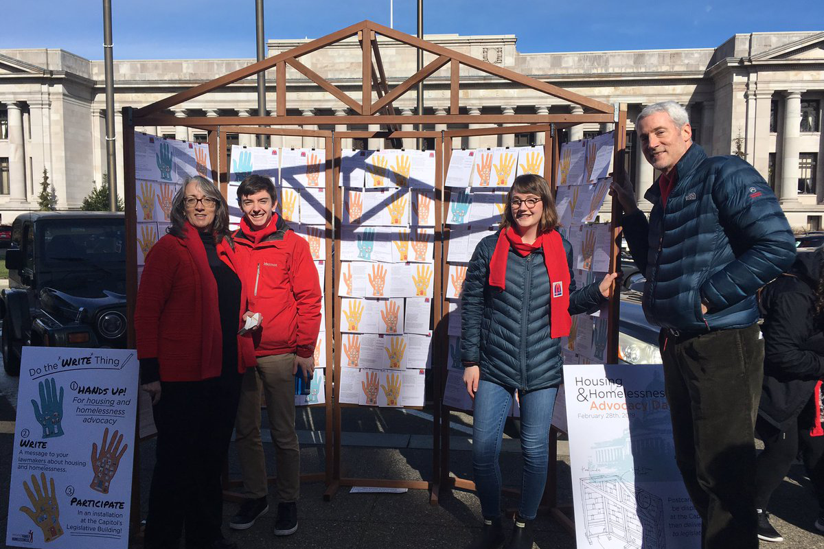 SU Project on Family Homelessness Project Assistants Connor and Anneka stand by their board containing messages from SU students on why affordable housing is important to them