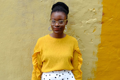 Picture of Black woman against yellow wall