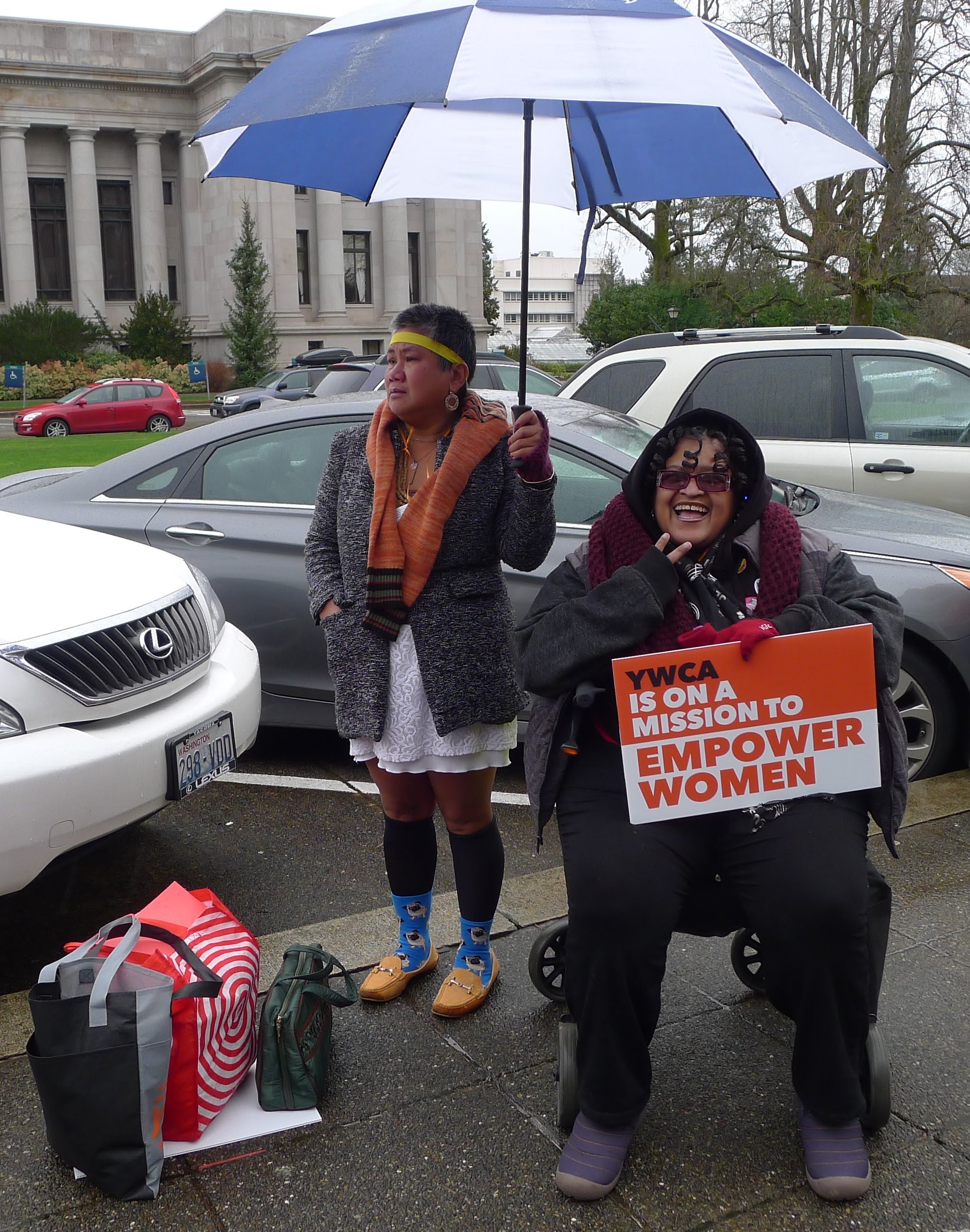Gertrude holds an umbrella for a fellow YWCA member
