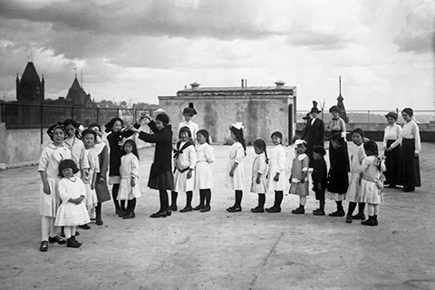 Children playing on rooftop of building