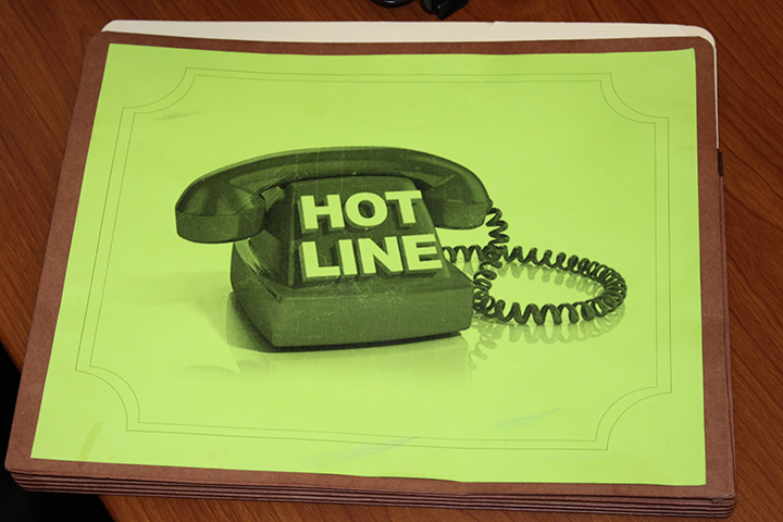 A folder with the word "hotline" printed on it is shown.