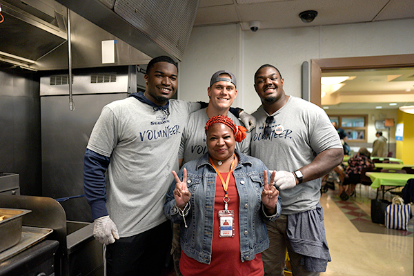 Seahawks Legends players volunteering at YWCA Angeline's 