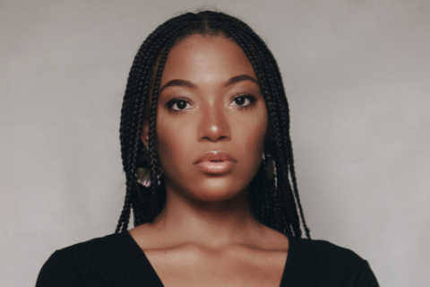 Portrait photo of Black woman with braids