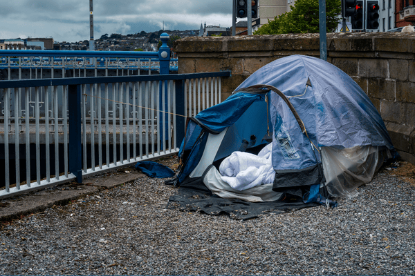 Blue tent in the middle of a city.