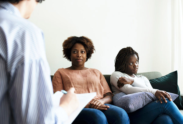 A Black mother and daughter in a health office