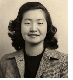Black and white portrait photo (tinted yellow) of Monica Sone
