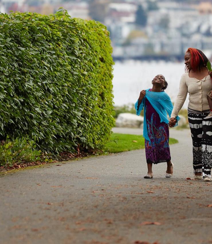 Photo of family of three walking in park