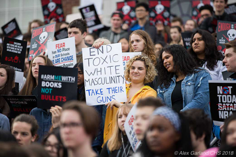 Students hold signs at the rally at Red Square in Seattle