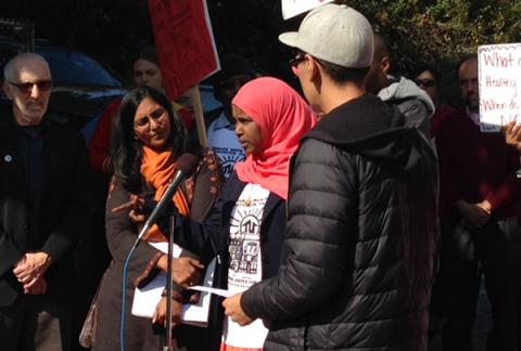 Sahro Farah stands at the microphone at a press conference outside of her apartment building.