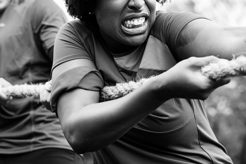 A black recruit pulls on a rope during exercises