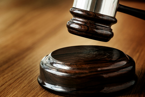 A gavel in a court room is shown