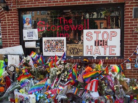 The Stonewall Inn with flowers and signs after Pride Weekend, 2016