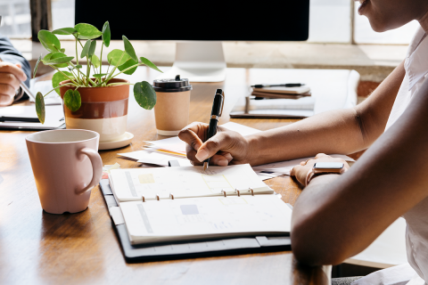 A Black woman writes a schedule