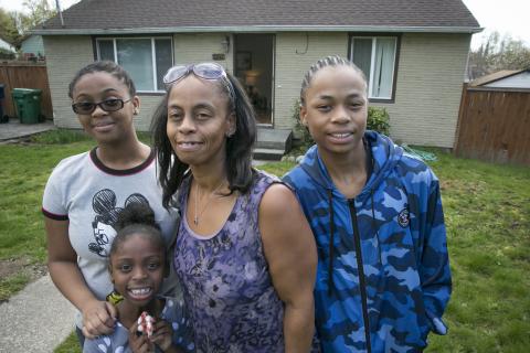 Picture of family standing in front of house