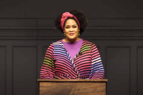 Picture of Ijeoma Oluo standing at a podium