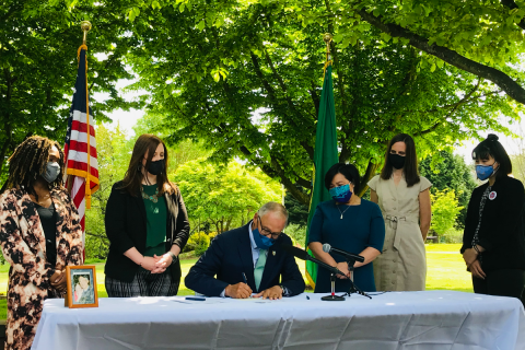 Gov. Jay Inslee signs the Working Families Tax Credit into law