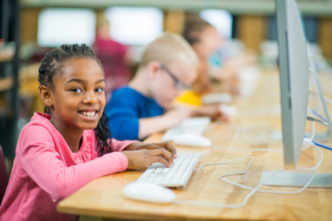 Picture of an African American girl working in a computer lab