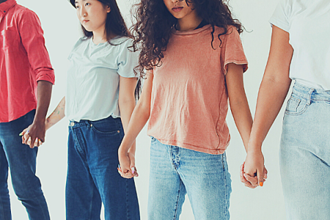 Picture of four young people holding hands
