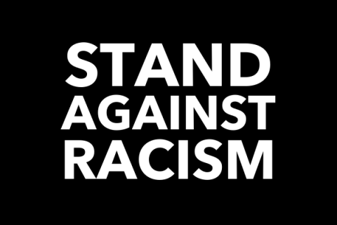 Black graphic with white text that says "Stand against racism"